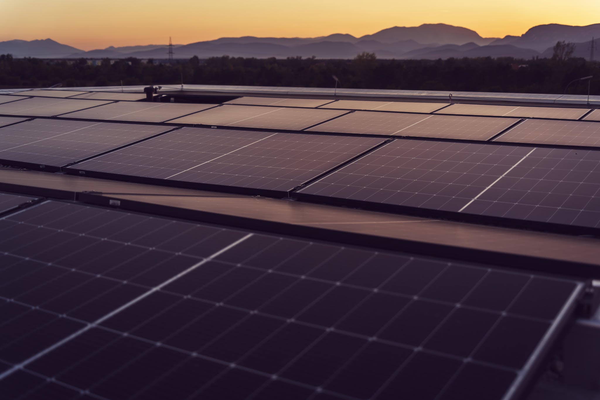 Solar panels on a roof at sunset